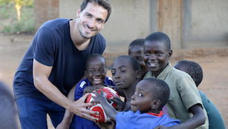 Mats Hummels spielt mit afrikanischen Kindern der Hilfsorganisation UNICEF