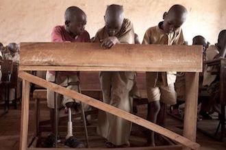 African student with prosthesis during school class