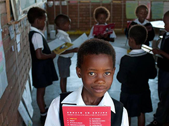 Roger Federer Foundation student with textbooks